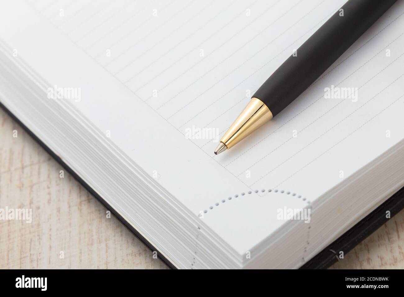 Notepad with ball pen on a wood background Stock Photo - Alamy