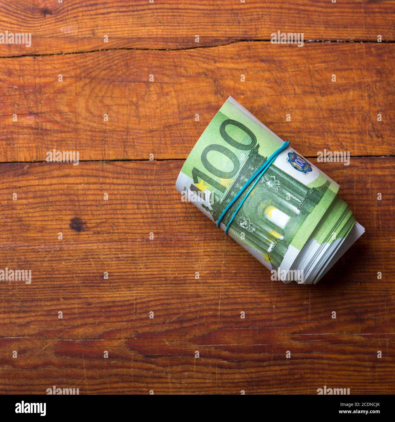 Roll of one hundred euro banknote Stock Photo - Alamy