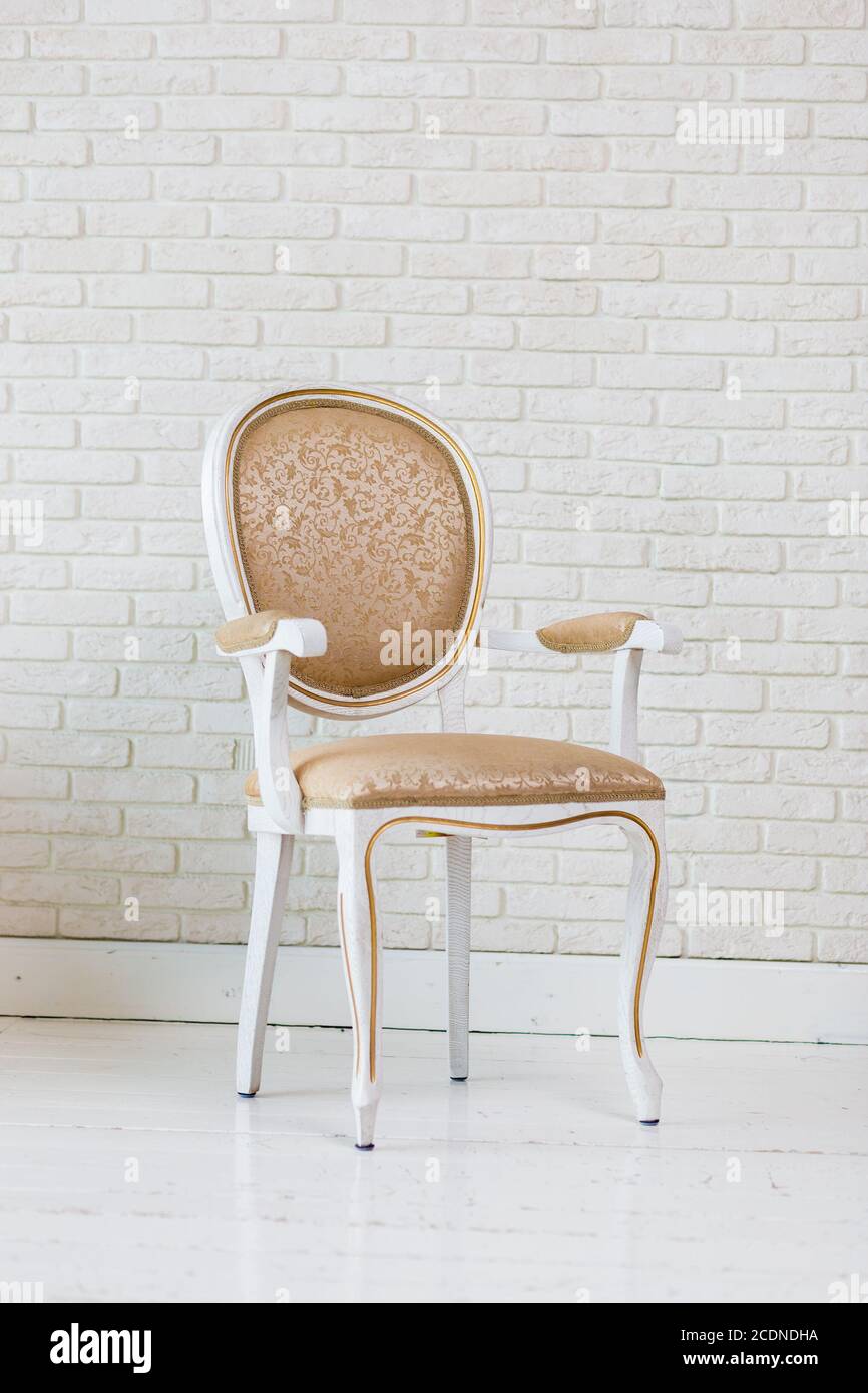 Luxury Golden Vintage Chair On Brick Wall Stock Photo