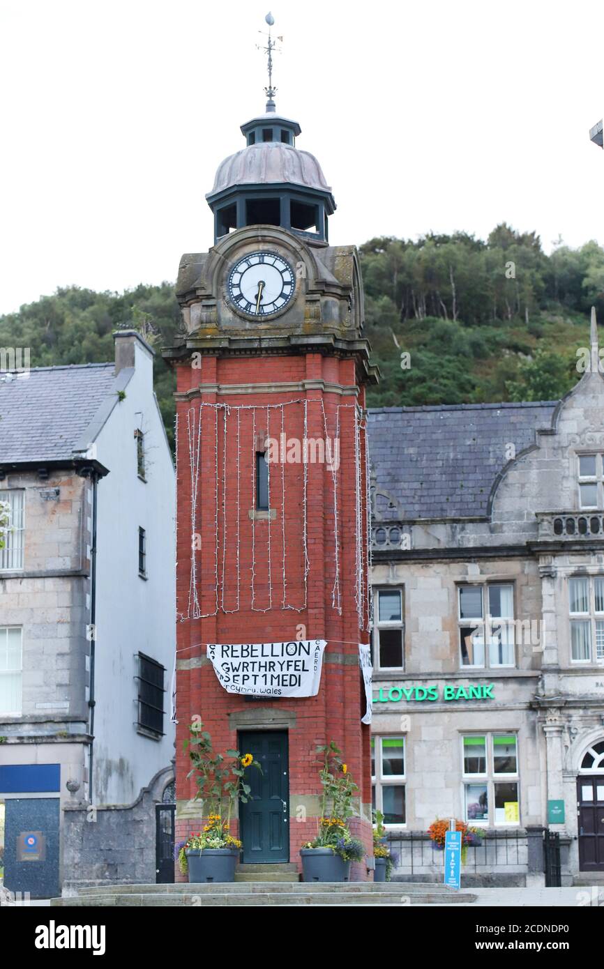 The Clock Tower, Bangor, Gwynedd 29 August 2020. Climate activists from Extinction Rebellion hang banners on the town clock in the early hours of the morning as part of a series of actions taking place across the UK over the next four days. Credit: Denise Laura Baker/Alamy Live News Stock Photo