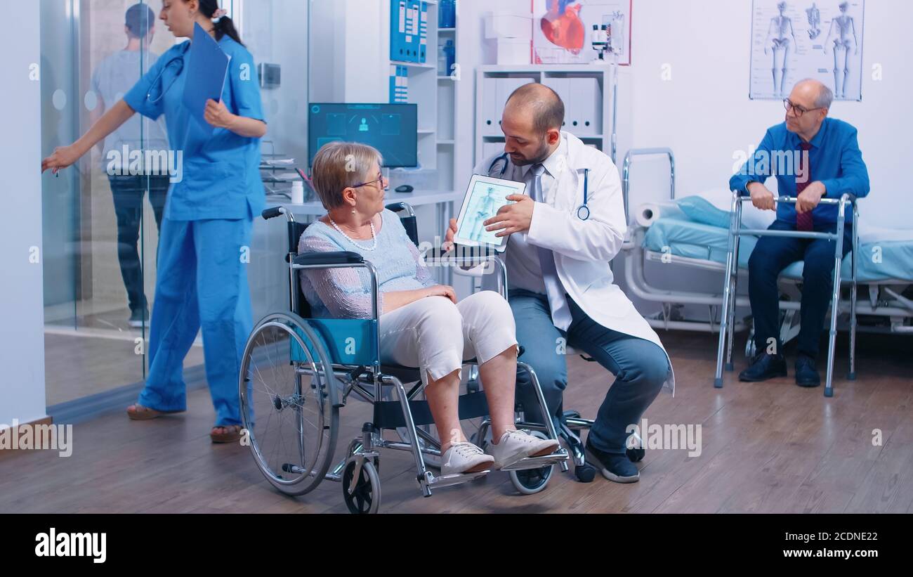 Doctor showing the osteoporosis risk for elderly persons to a senior