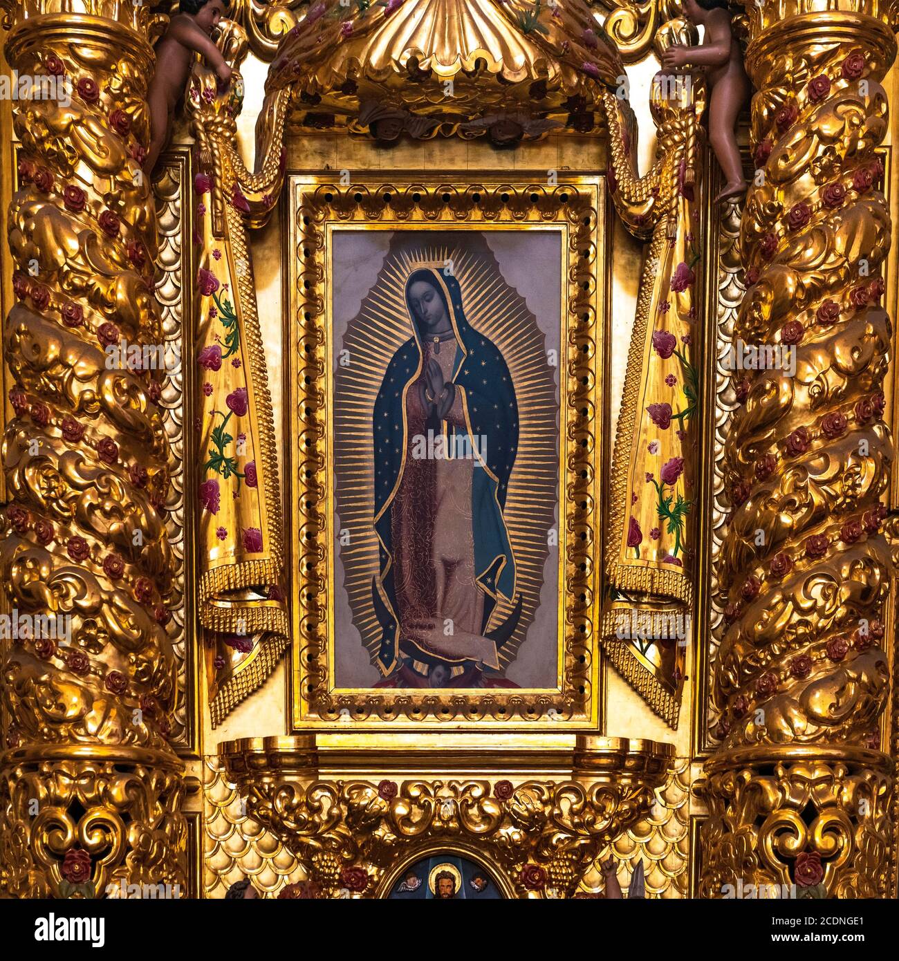 Painting of Our Lady of Guadalupe Virgin Mary in a gold leaf decoration altar in baroque style inside the Santo Domingo Cathedral, Oaxaca, Mexico. Stock Photo