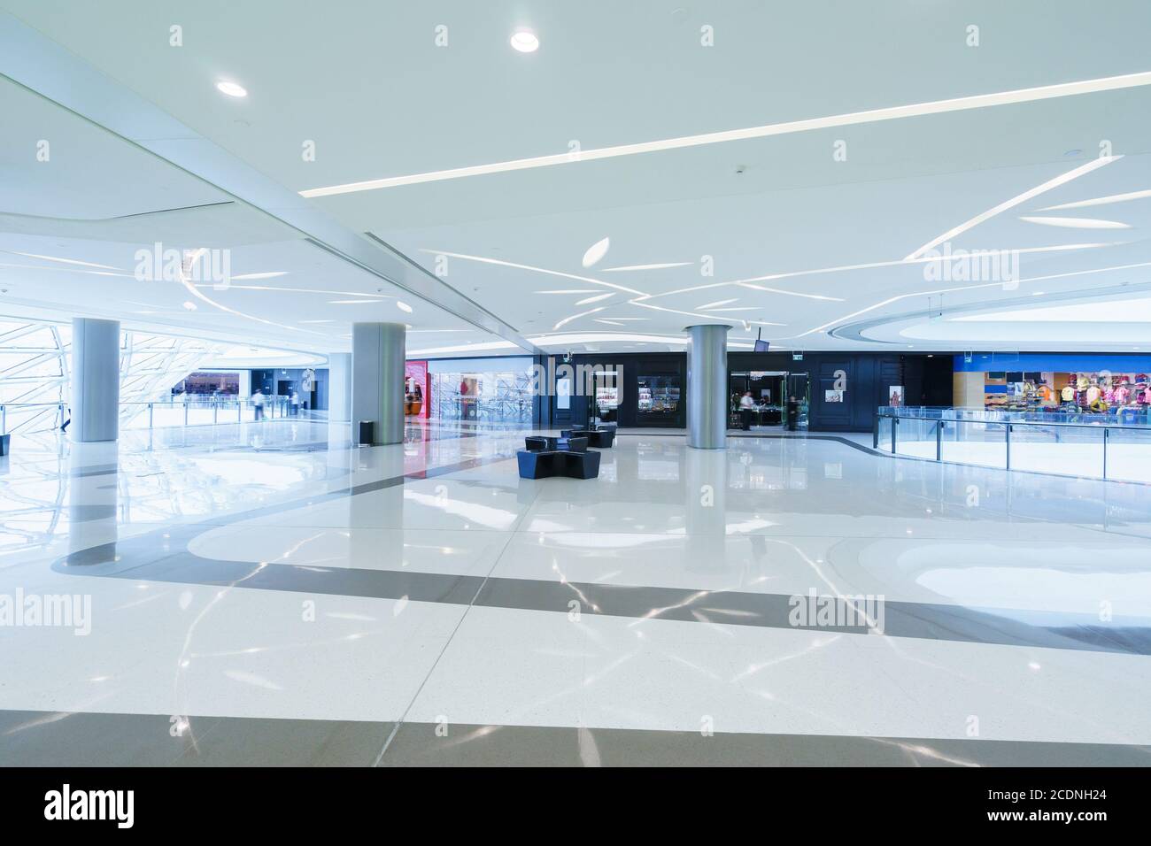 empty hallway with a huge billboard and abstract ceiling in modern shopping mall Stock Photo