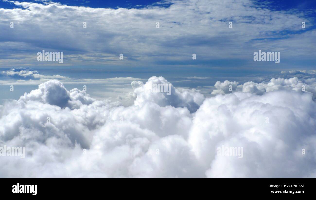 Blue sky with towering white cumulus clouds Stock Photo