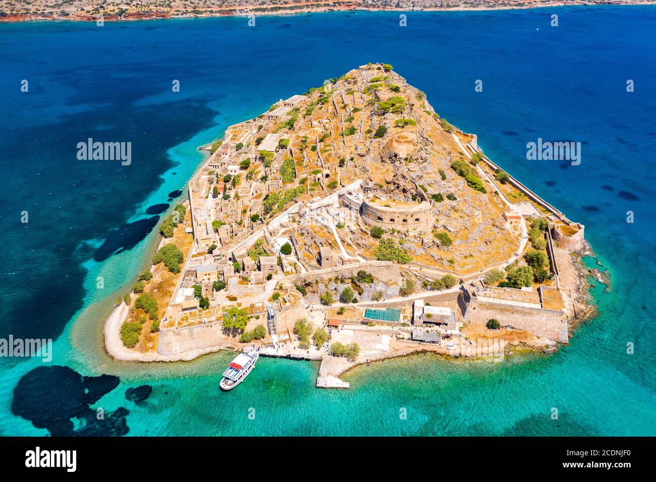 View of the island of Spinalonga with calm sea. Here were isolated ...