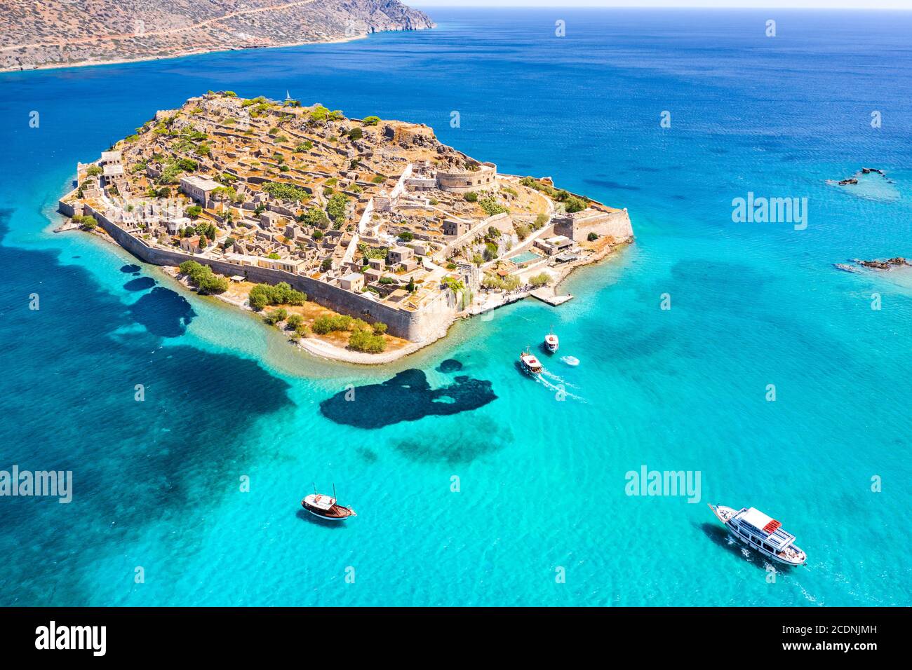 View of the island of Spinalonga with calm sea. Here were isolated lepers, humans with the Hansen's desease, gulf of Elounda, Crete, Greece. Stock Photo