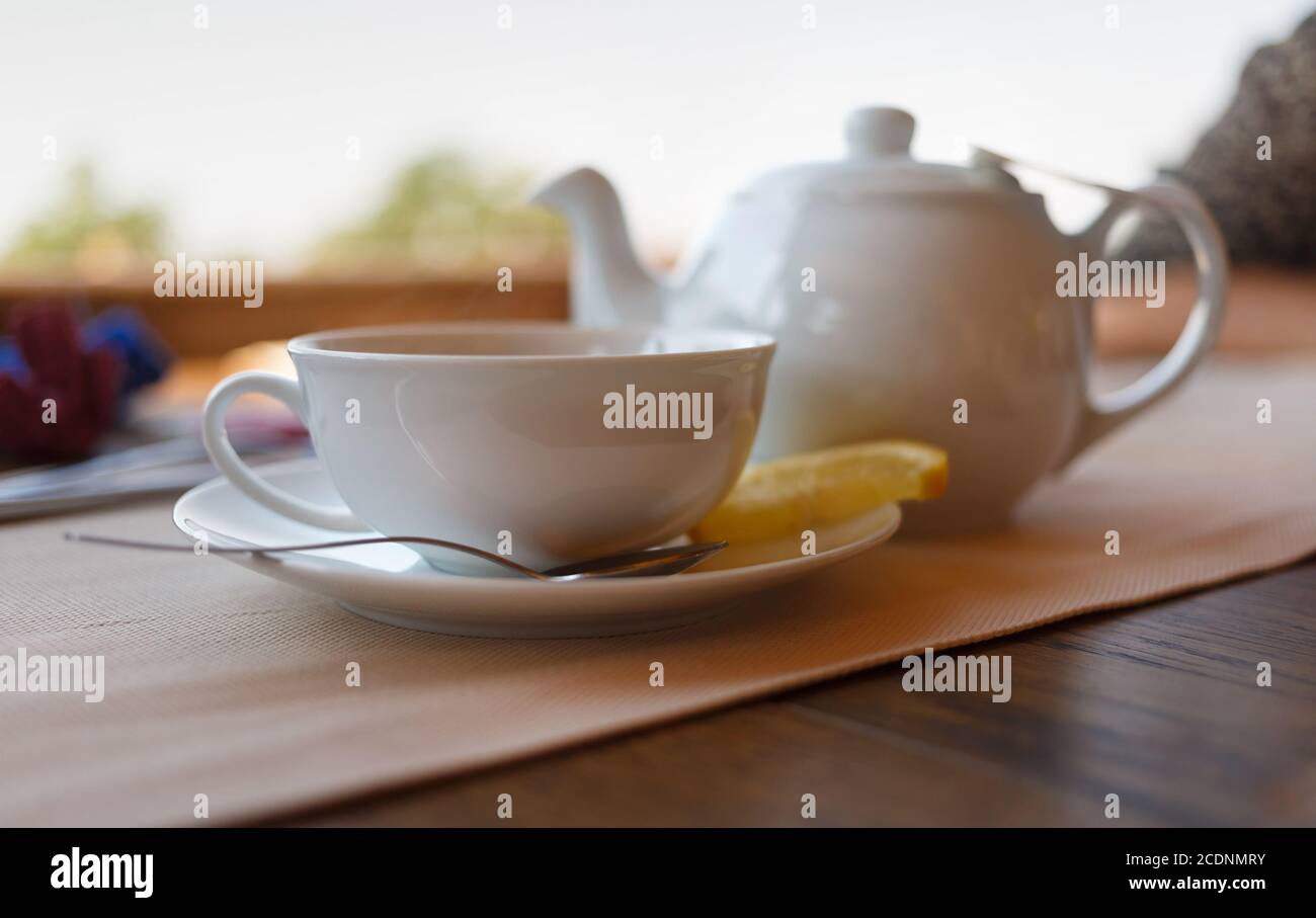 Tea with lemon and tea maker Stock Photo