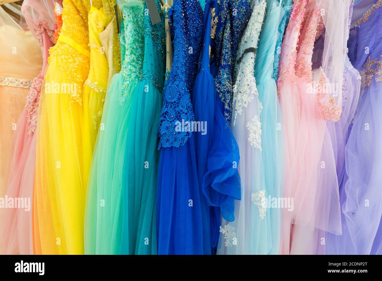 ladies evening dresses of different colors at shop Stock Photo