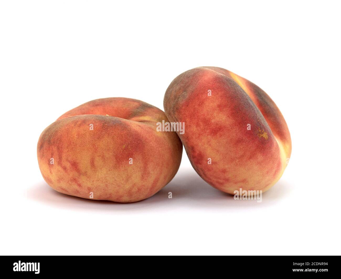 Flat peaches isolated against a white background Stock Photo