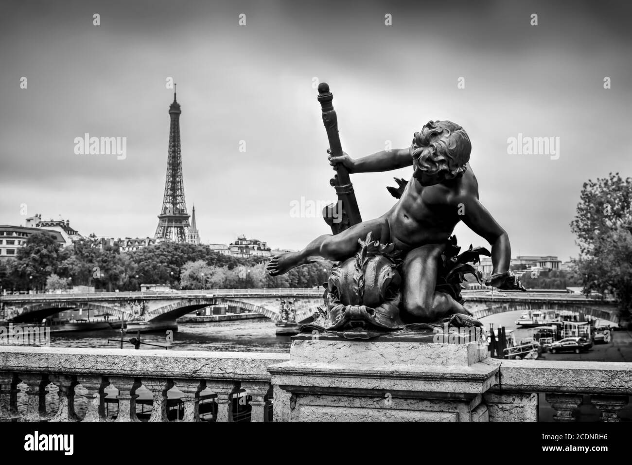 Statue on Pont Alexandre III bridge in Paris, France. Seine river and Eiffel Tower. Stock Photo