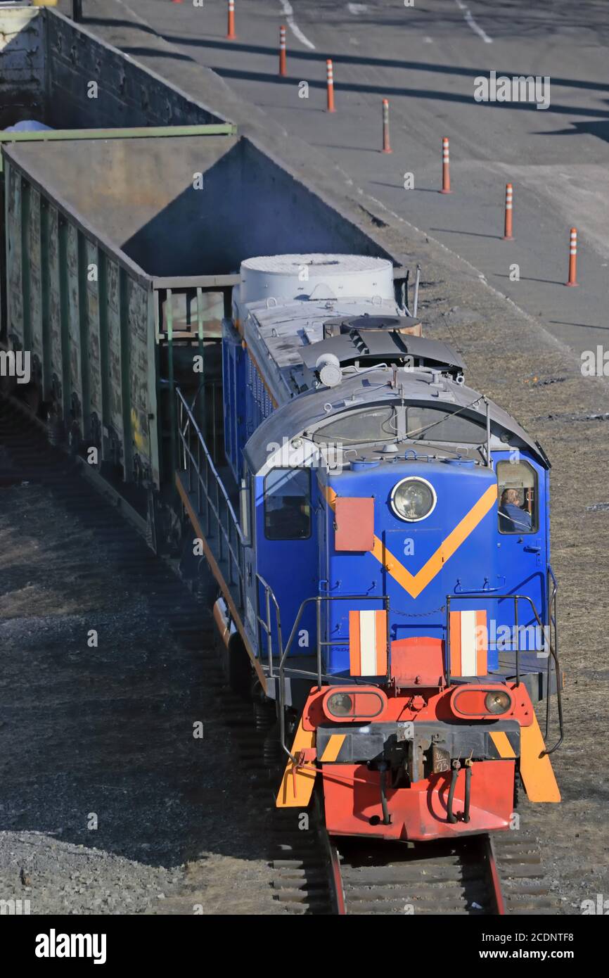 Freight train hauled by diesel locomotive. Stock Photo
