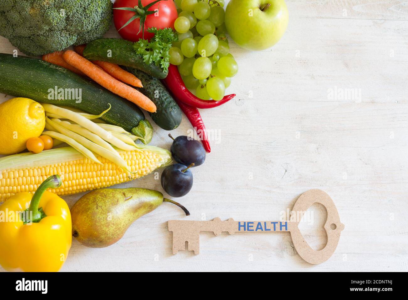 Key to health. Vegetables and fruits with key, healthy lifestyle concept Stock Photo