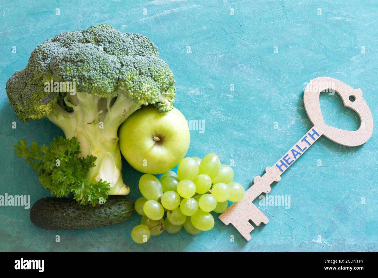 Key to health. Vegetables and fruits with key, healthy lifestyle concept Stock Photo