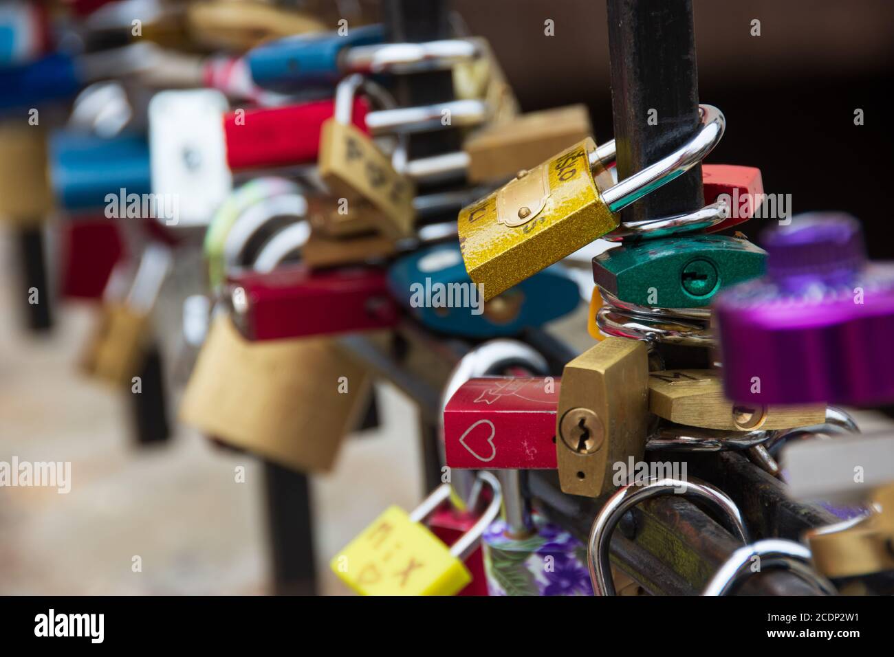 Love padlocks, one of them red with a white heart. Concepts of attachment and eternal love Stock Photo