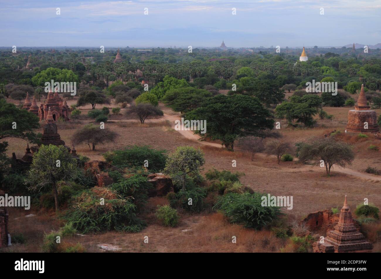 Aerial view of the Old Bagan showing the ancient pagodas and temples amidst the lust greeneries and dirt roads Stock Photo