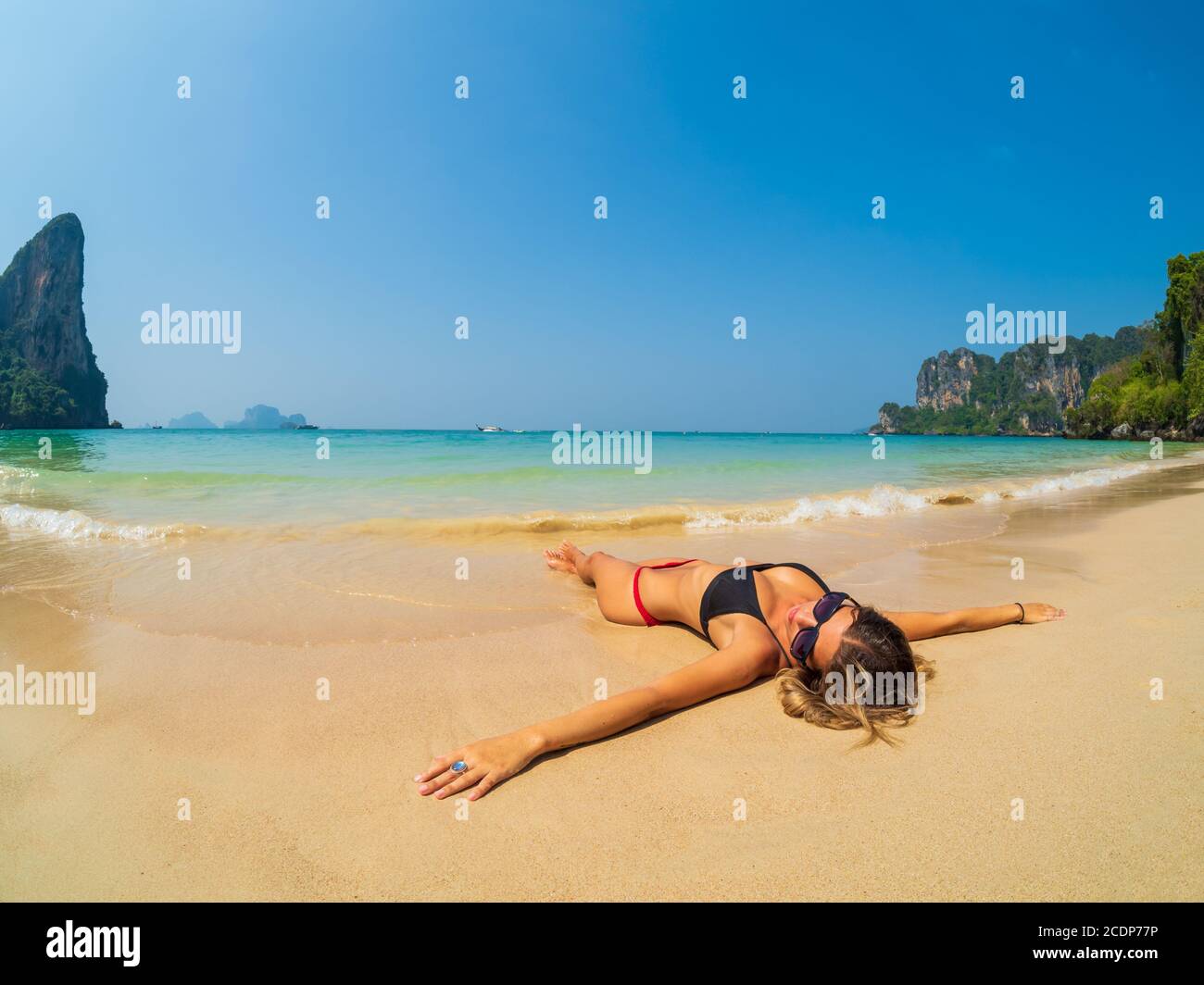 Woman on the Thai beach of Railay in Krabi Thailand Stock Photo