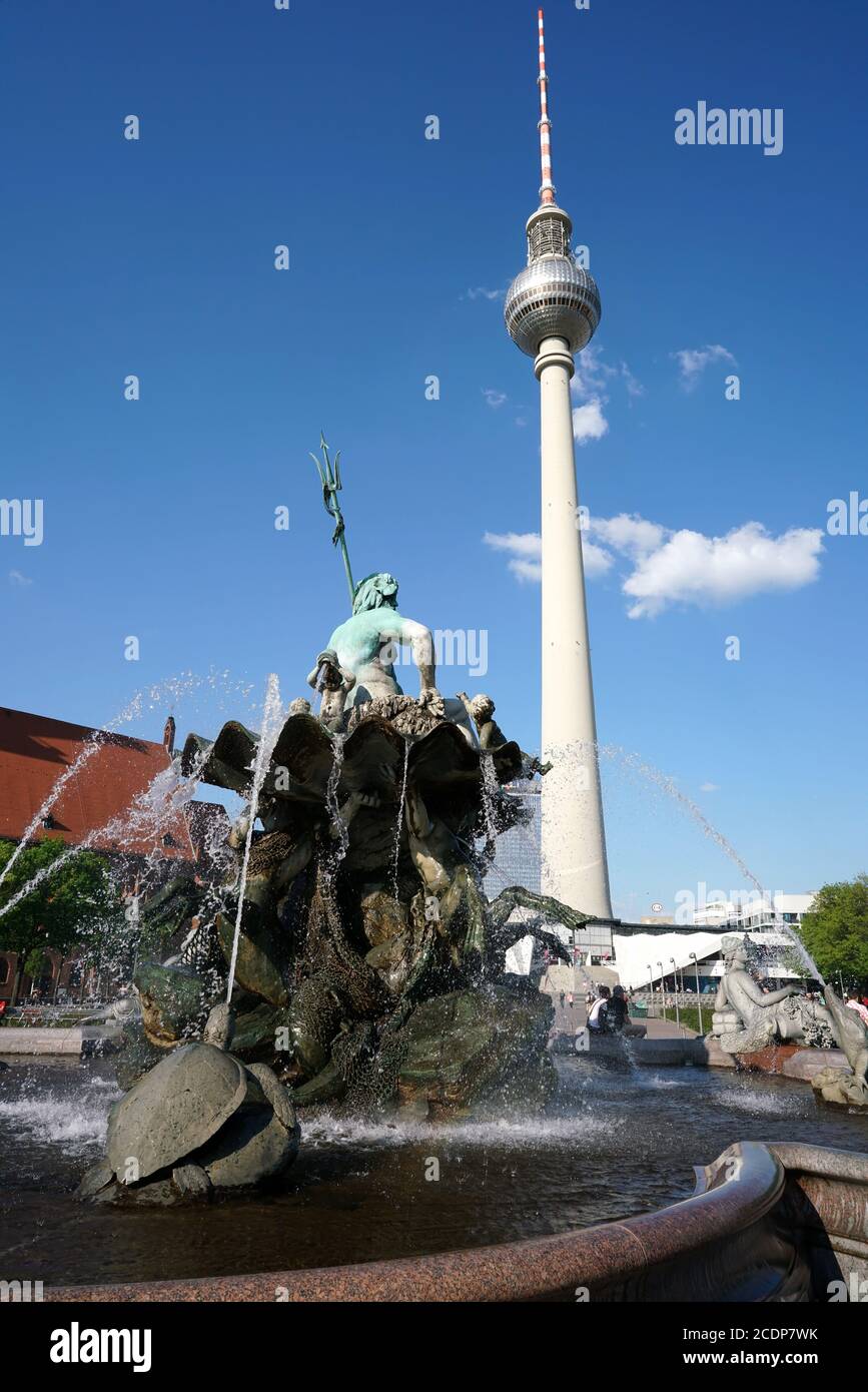 TV tower and Neptunbrunnen in Berlin. Two landmark and tourist magnets in downtown Berlin Stock Photo