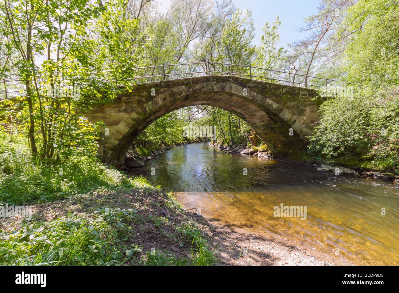 Restored, historic arch bridge from the 17th century on the White Main at the beginning of the Baill Stock Photo