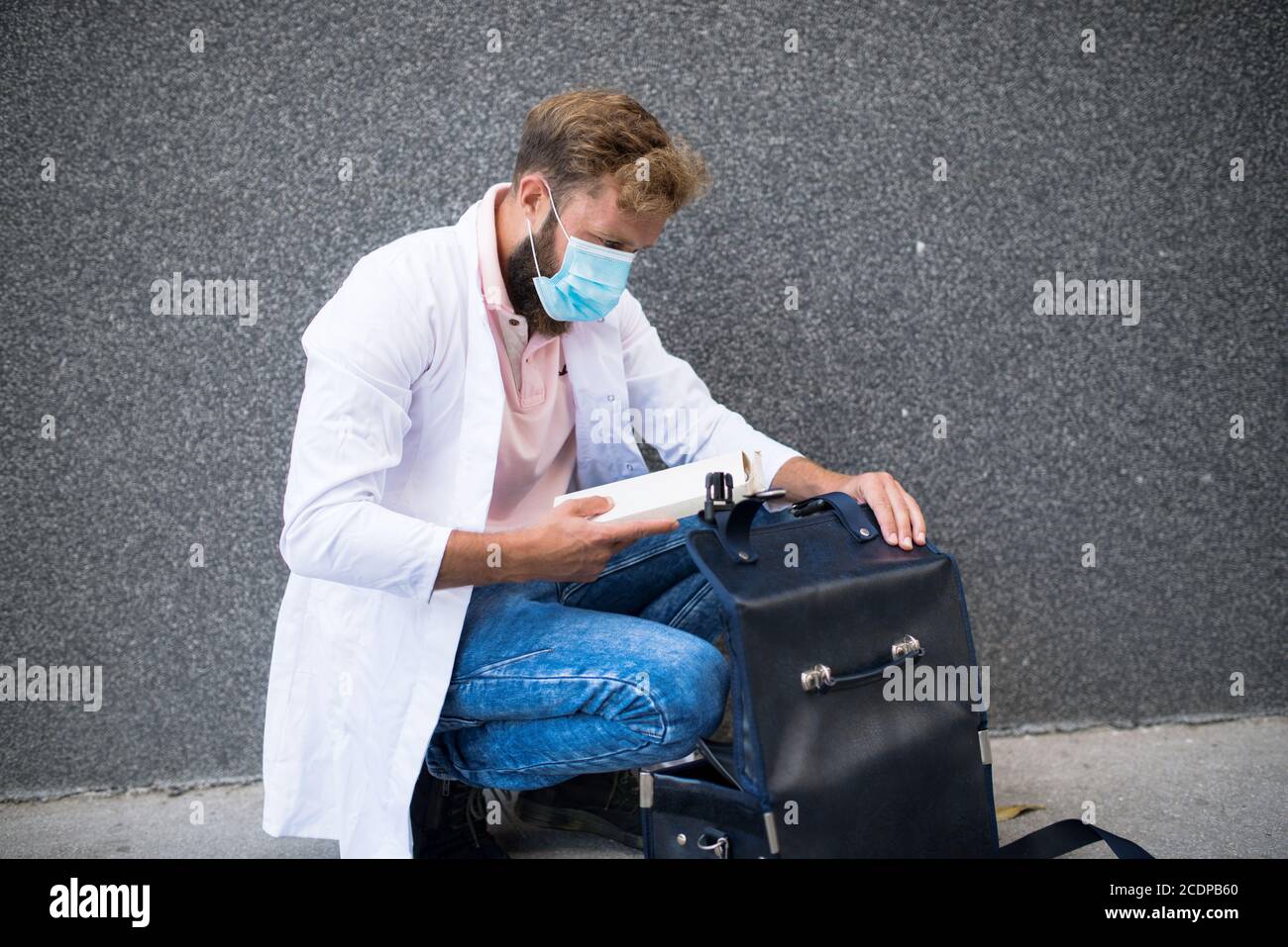 young doctor carrying a doctor's bag Stock Photo Alamy