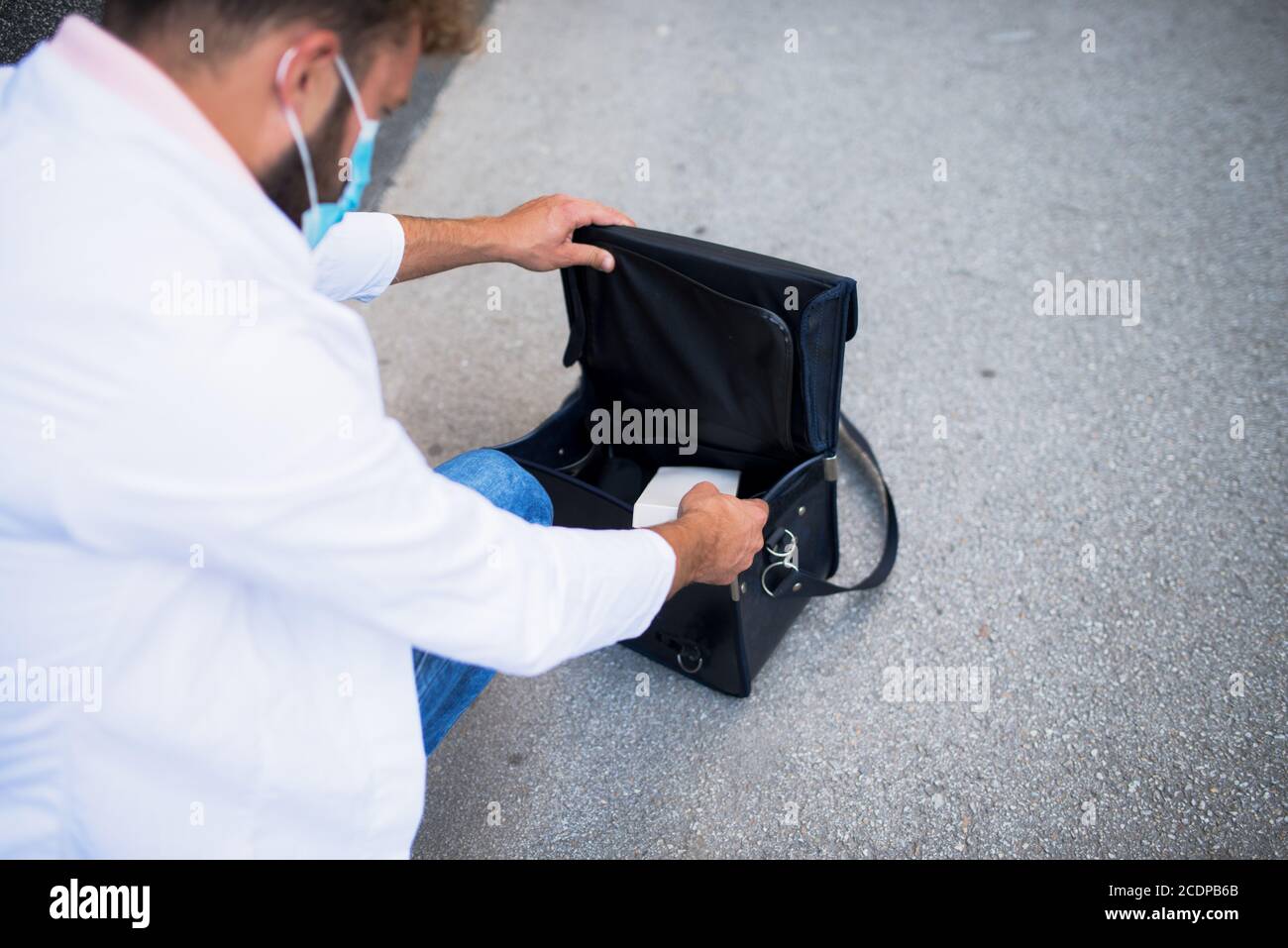 young doctor carrying a doctor's bag Stock Photo Alamy