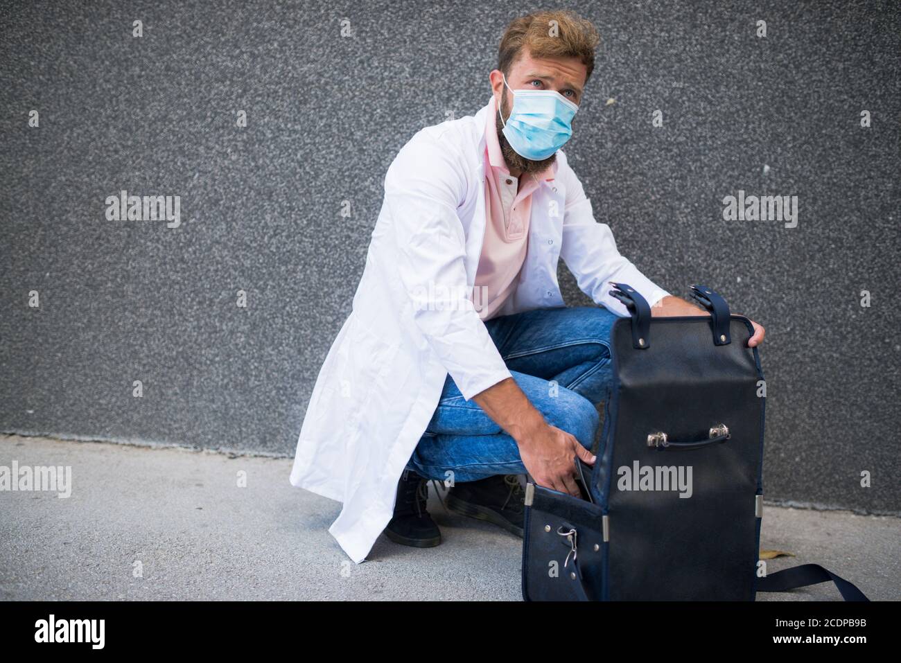 young doctor carrying a doctor's bag Stock Photo Alamy