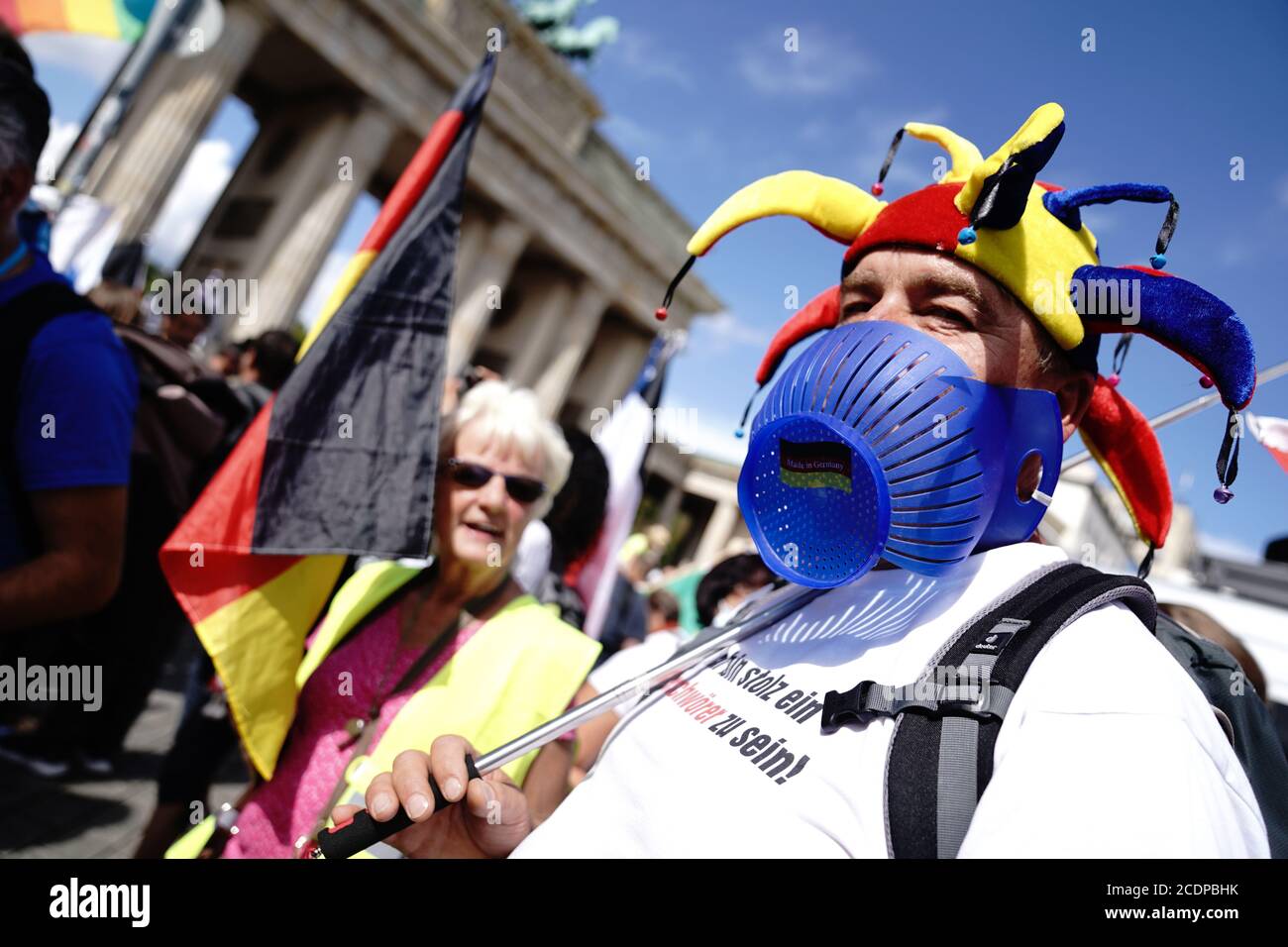 Berlin, Germany. 29th Aug, 2020. A participant wears a fool's cap at the Brandenburg Gate during a demonstration against the Corona measures. Credit: Kay Nietfeld/dpa/Alamy Live News Stock Photo