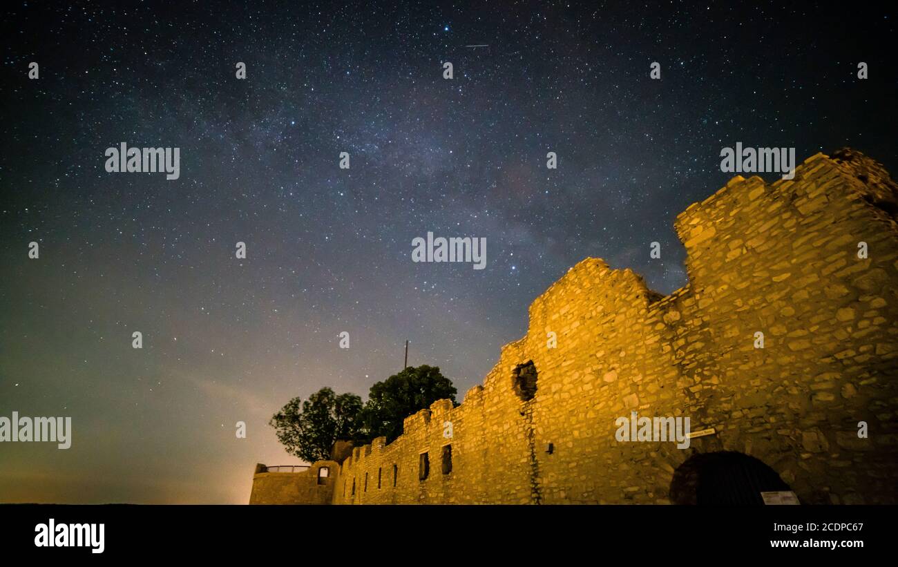 Germany, Night sky of millions of stars of the milky way galaxy above the castle ruins of Hohenneuffen Stock Photo