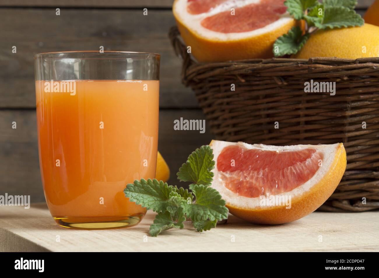 Natural and fresh grapefruit juice in glass with freshly harvested grapefruit Stock Photo