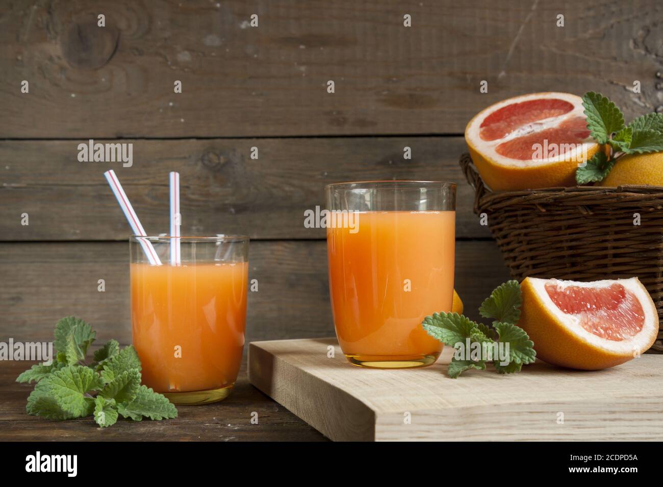 Natural and fresh grapefruit juice in glass with freshly harvested grapefruit Stock Photo