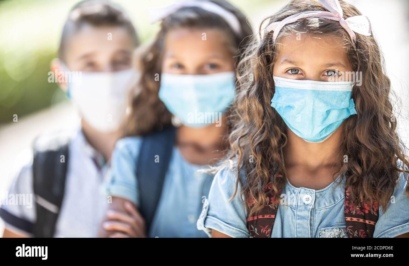 Portrait of schoolchildren with face masks during Covid-19 quarantine. Stock Photo