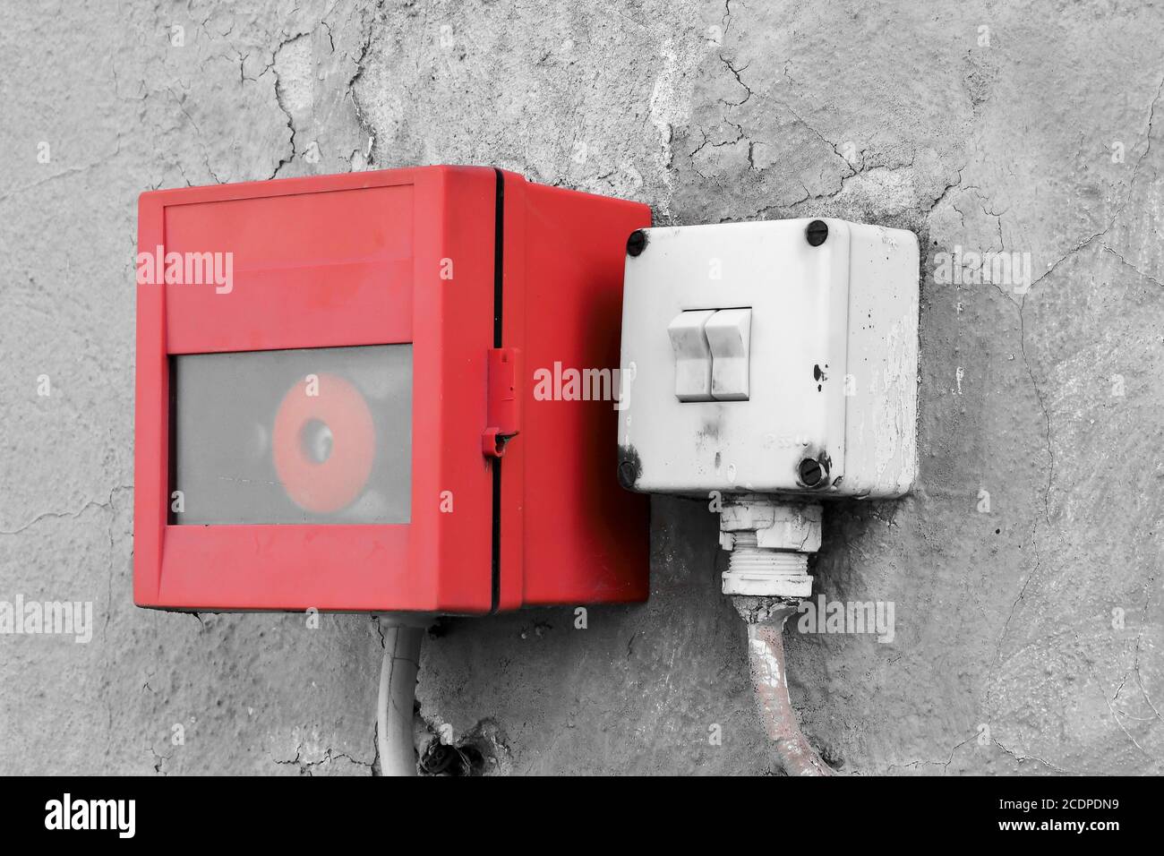 emergency switch and light switch on the wall of a factory building Stock Photo