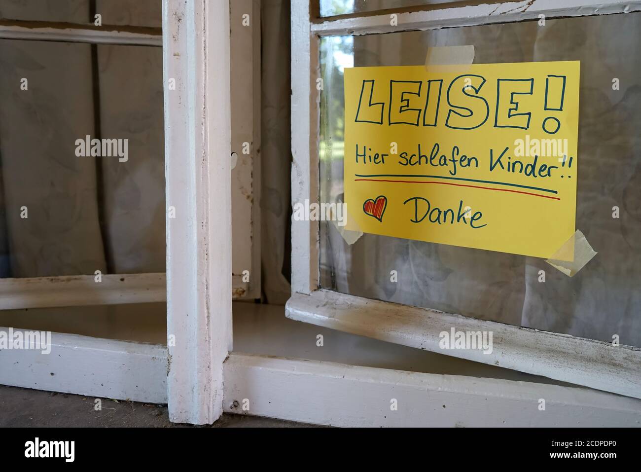 sign at a hostel window with the inscription Quiet, here sleeping children Stock Photo