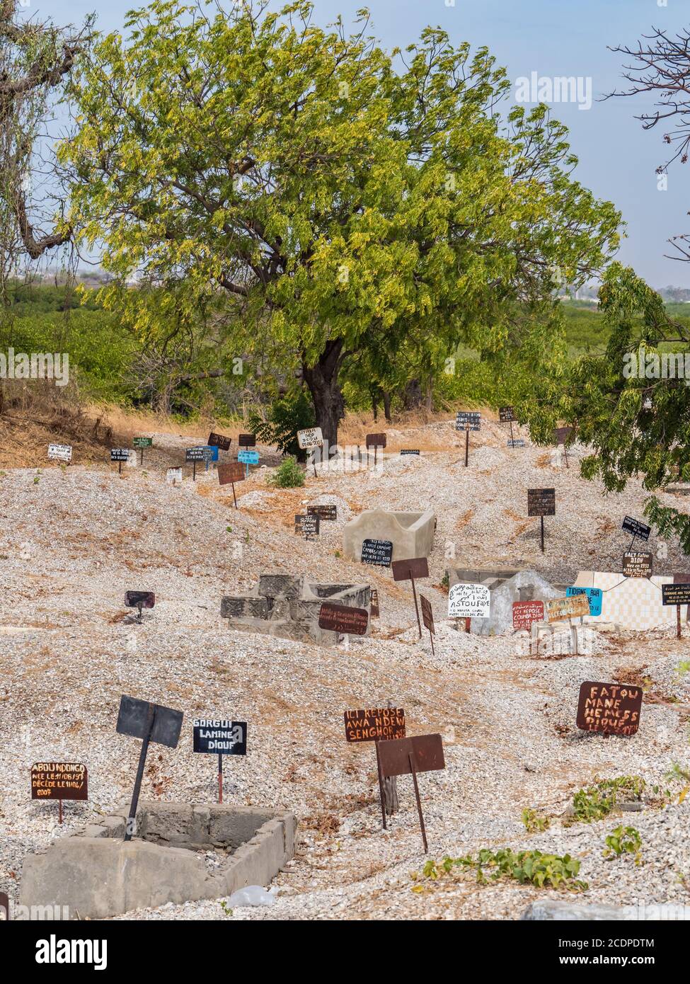 Joal-Fadiouth, Afrika - Jan, 2019: Metal tablets on the tomb of mixed Muslim-Christian cemetery. The city and municipality of Joal-Fadiouth in the Thi Stock Photo