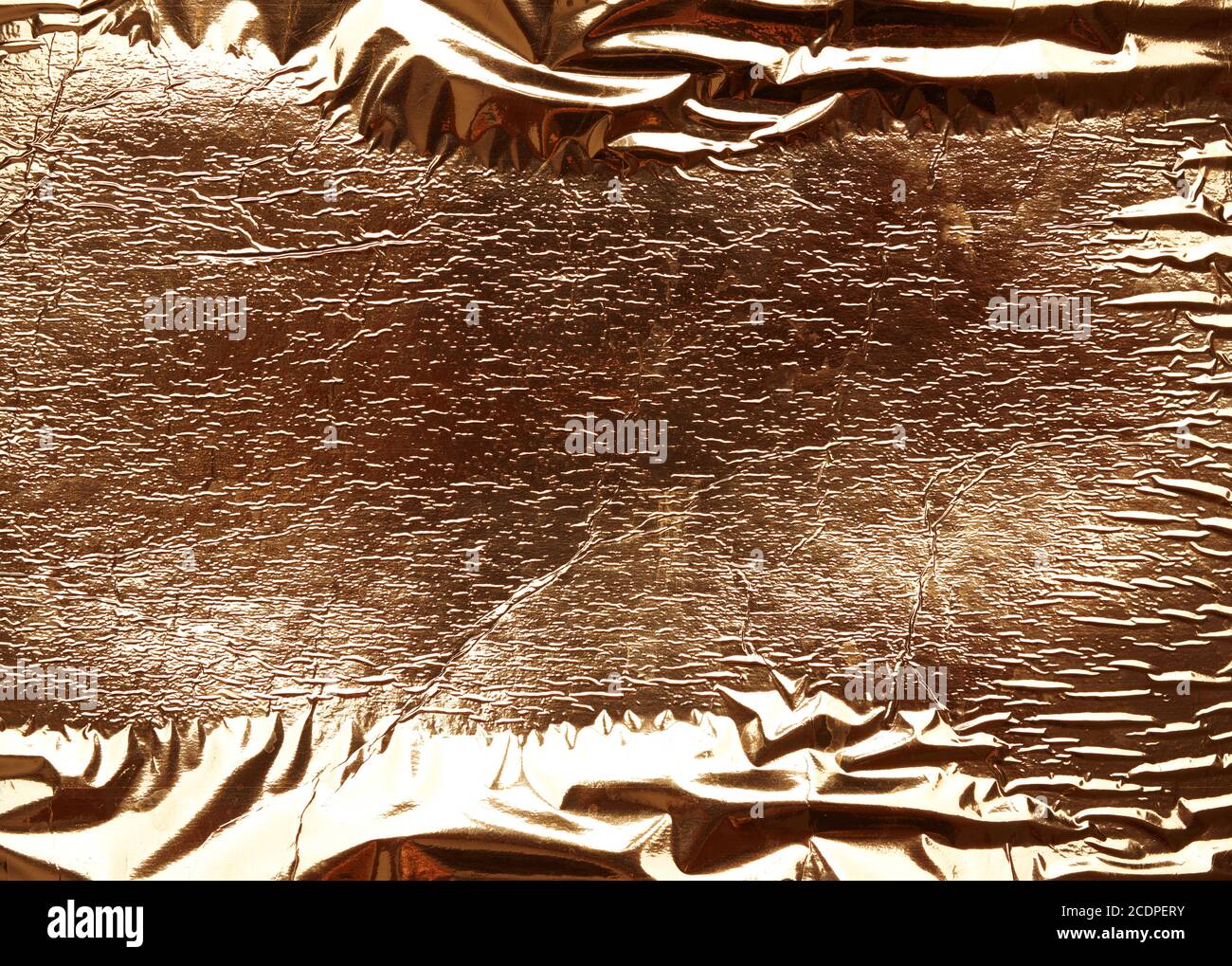 crumpled golden foil texture, full frame, close up Stock Photo