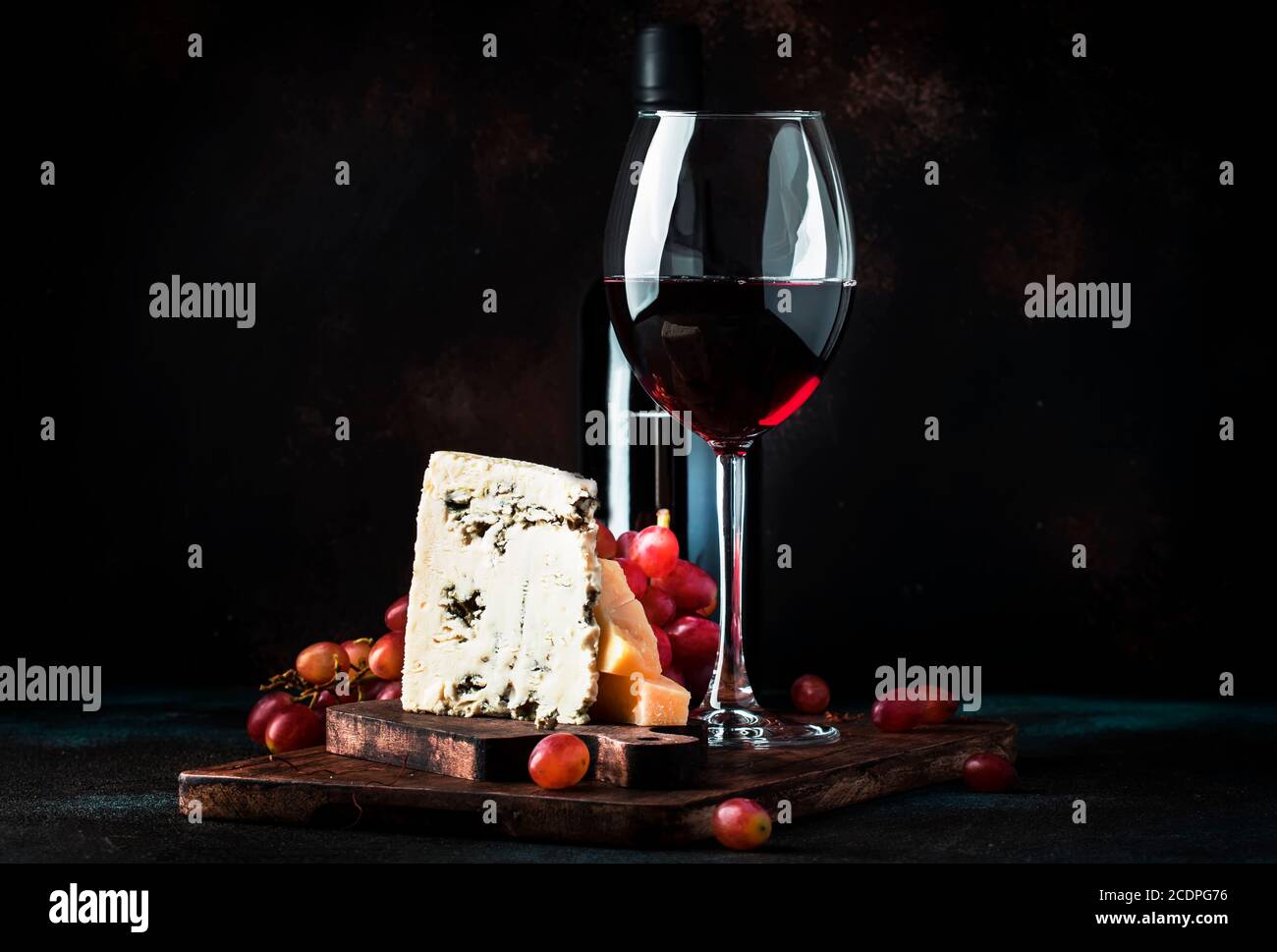 Port wine and blue cheese, still life in rustic style, vintage wooden table background, selective focus Stock Photo