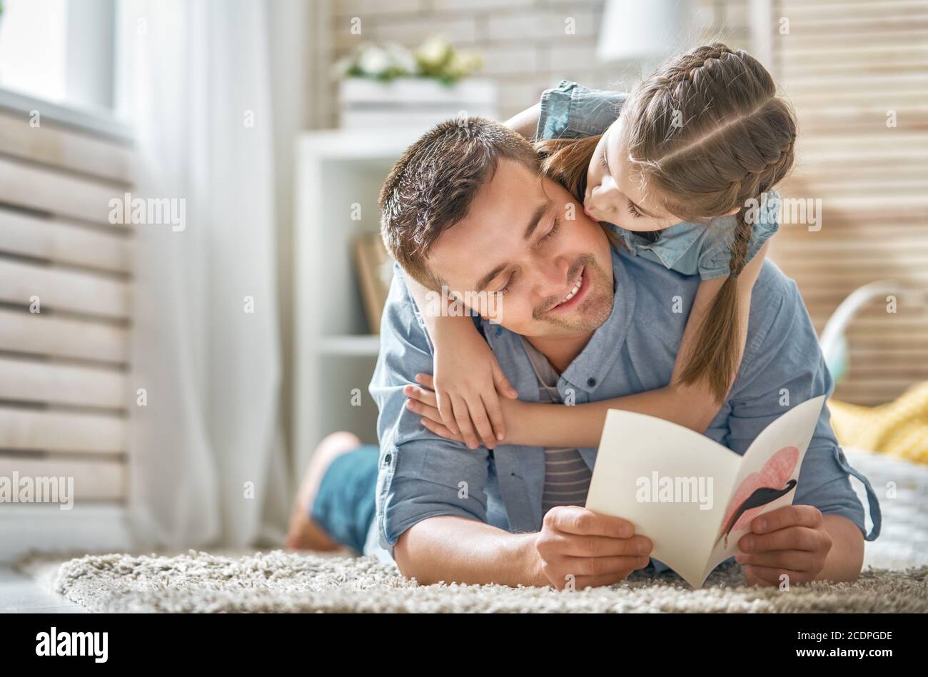 Happy father's day! Child daughter congratulating dad and giving him ...
