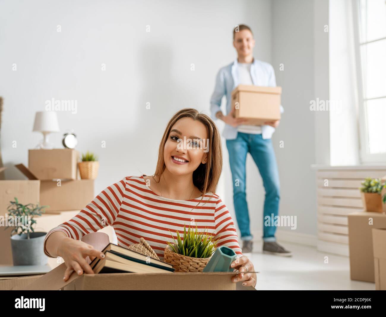 Happy young married couple are moving to new apartment Stock Photo - Alamy