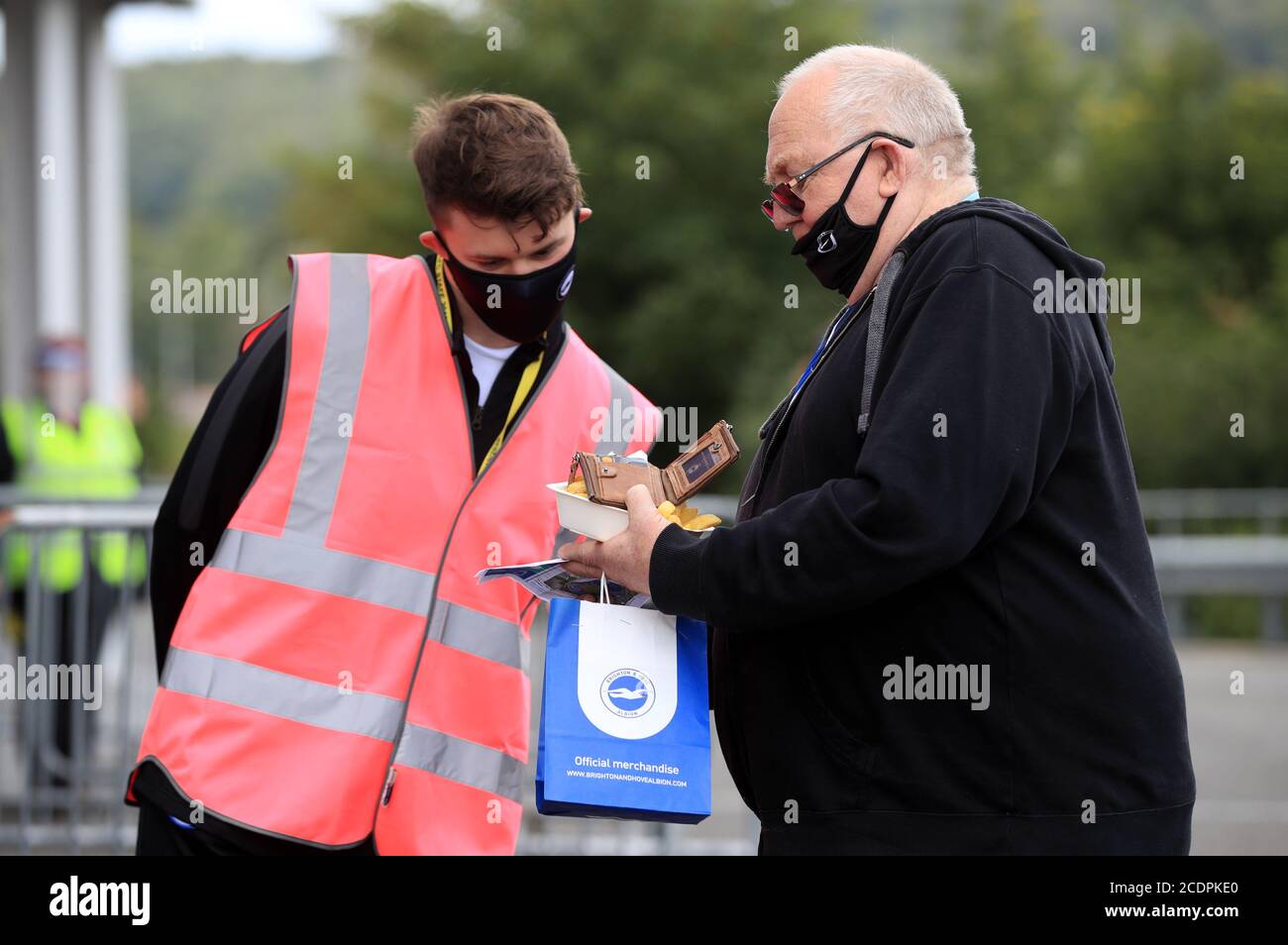 A fan shows their ticket prior to the pre-season friendly at the AMEX Stadium in Brighton where up to 2500 fans have been allowed in to watch the match after the Government announced a further batch of sporting events that will be used to pilot the safe return of spectators. Stock Photo