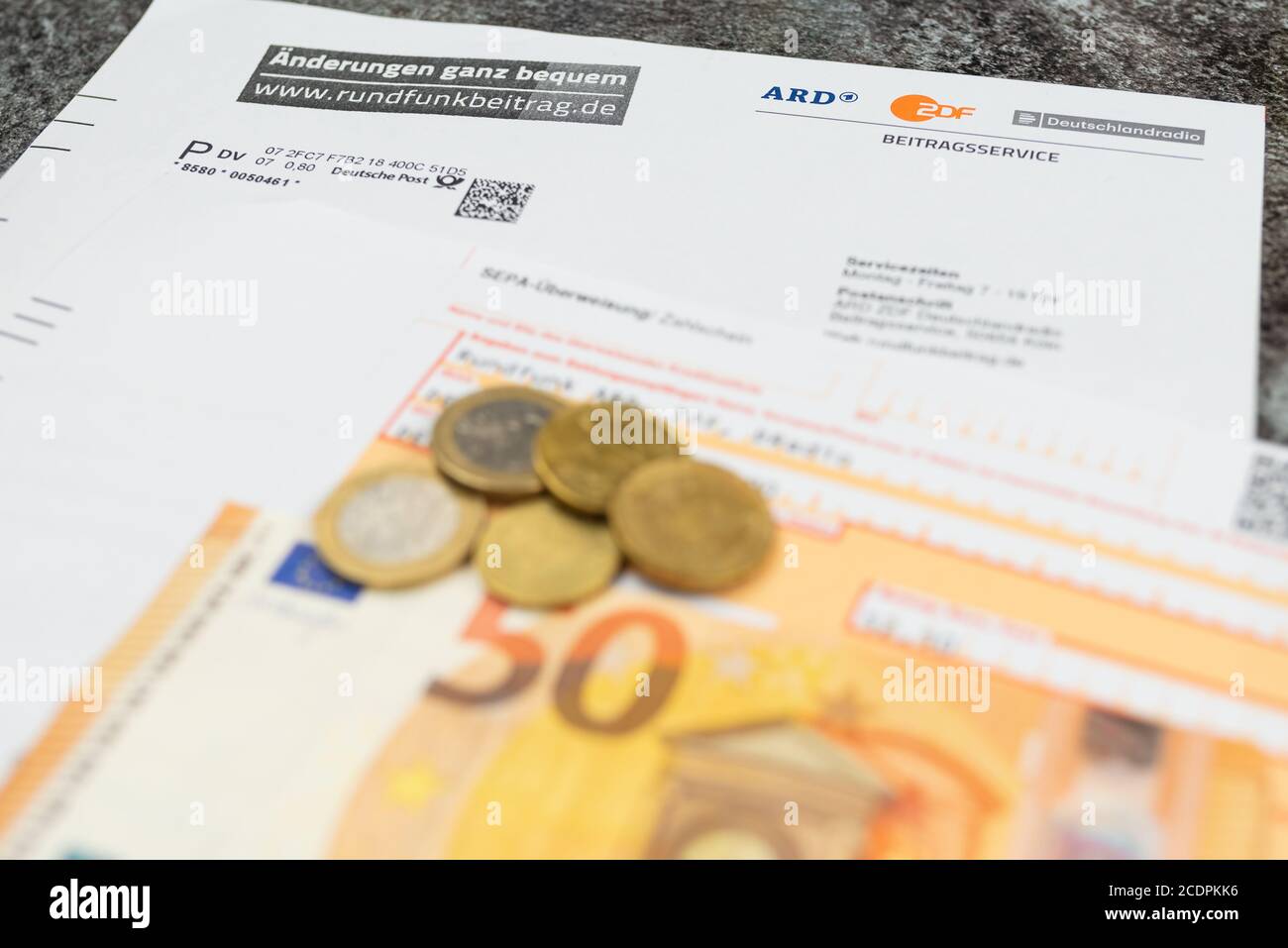 2020-08-29 Hamburg, Germany: close-up of quarterly invoice for tevevision and radio license fee and remittance slip on table Stock Photo