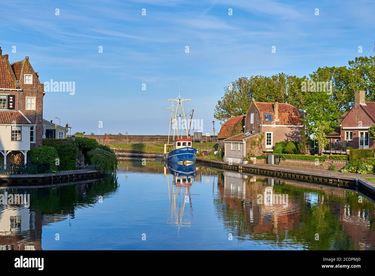 Picturesque view with water reflections and old historical buildings in Enkhuizen on the IJsselmeer in the Netherlands Stock Photo