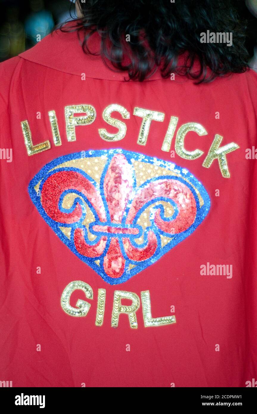 A Mardi Gras costume red cape reading 'Lipstick Girl' worn by a woman during the festival in Shreveport, Louisiana, United States. Stock Photo