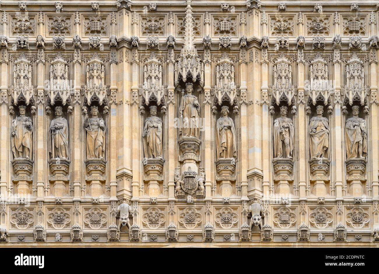 London, UK. Statues above the Sovereign's Entrance to the Houses of Parliament under the Victoria Tower. Queen Victoria in the middle, flanked by... Stock Photo