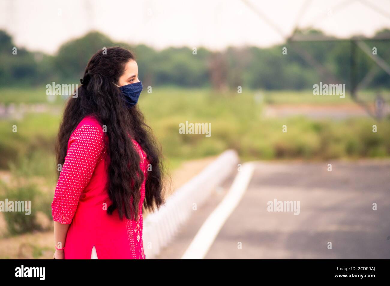 Young Indian girl wearing a mask, indian salwar kameez standing with a