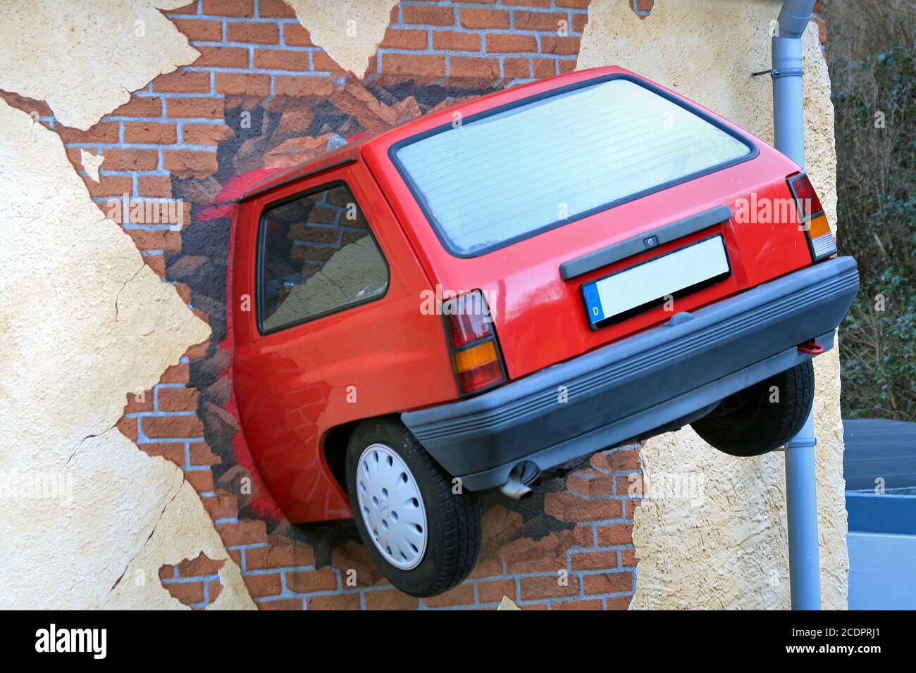 car stuck in a house wall Stock Photo