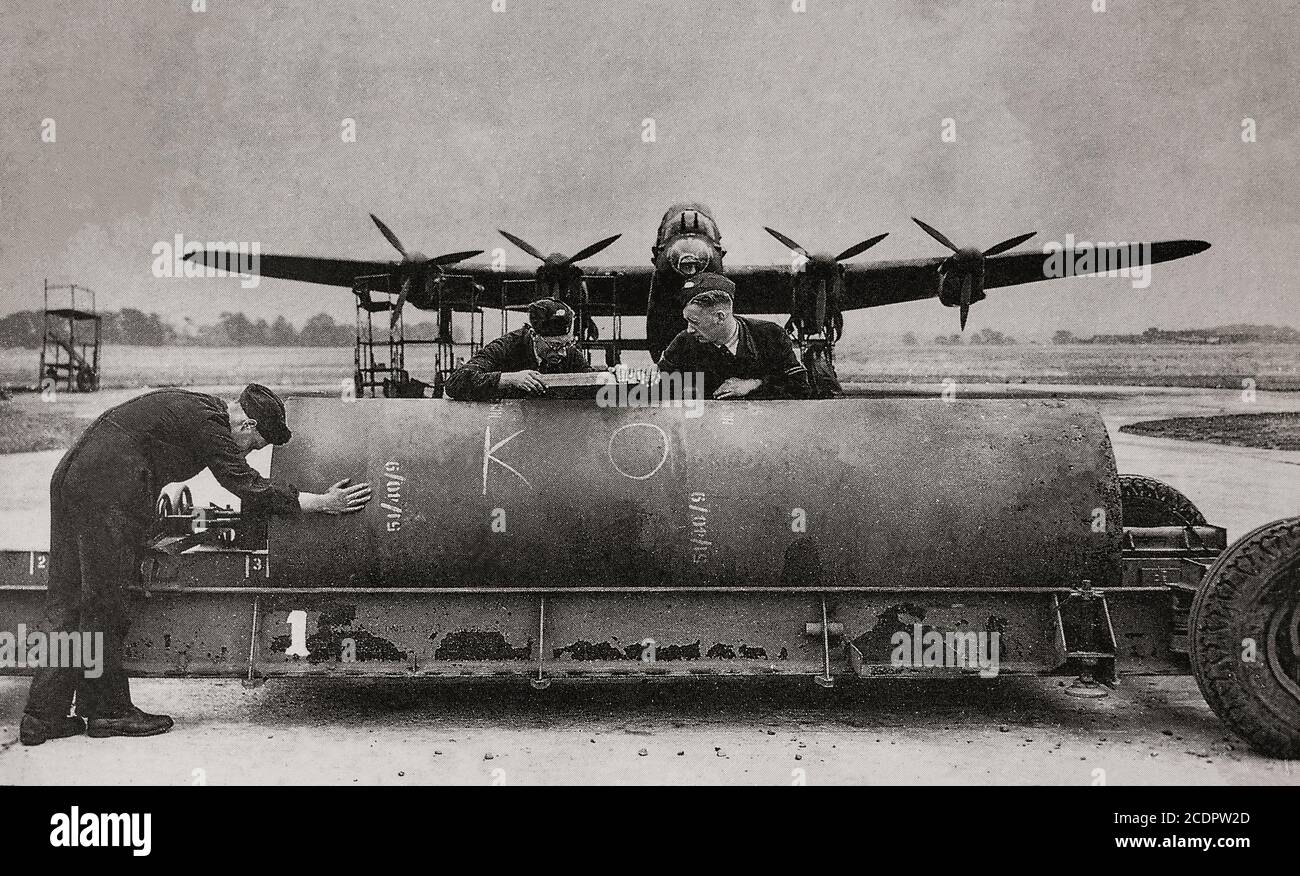 An 8,000 pound blast bomb being fitted to a Lancaster. Also called the blockbuster bomb, a term originally coined by the press and referred to a bomb which had enough explosive power to destroy an entire street or large building through the effects of blast in conjunction with incendiary bombs. Stock Photo
