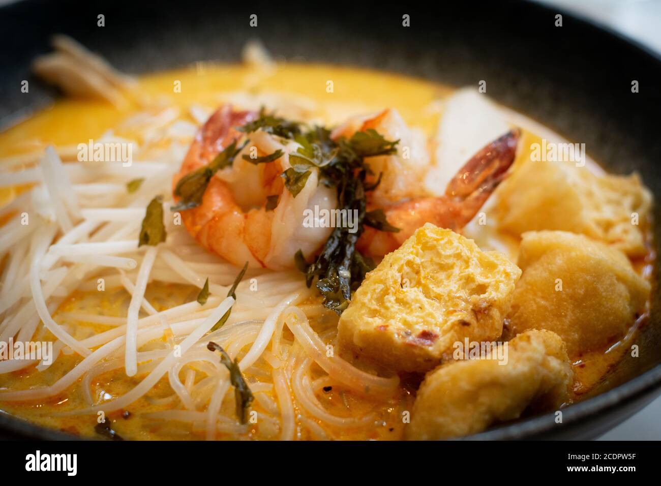 A bowl of laksa, typical soup from southeast asian which consists in