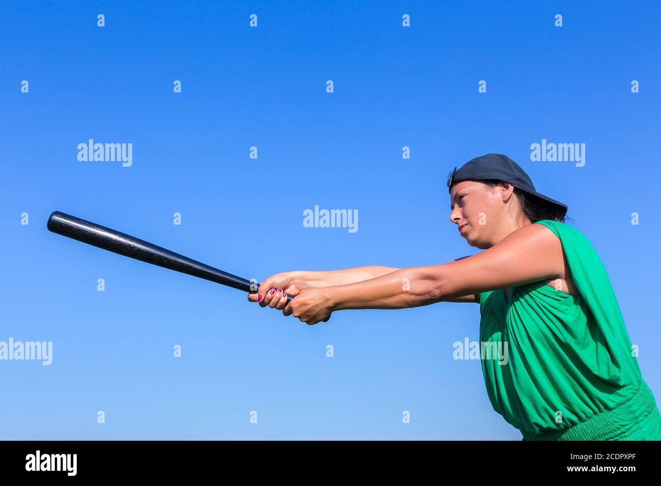 Woman with baseball bat body posture to strike Stock Photo