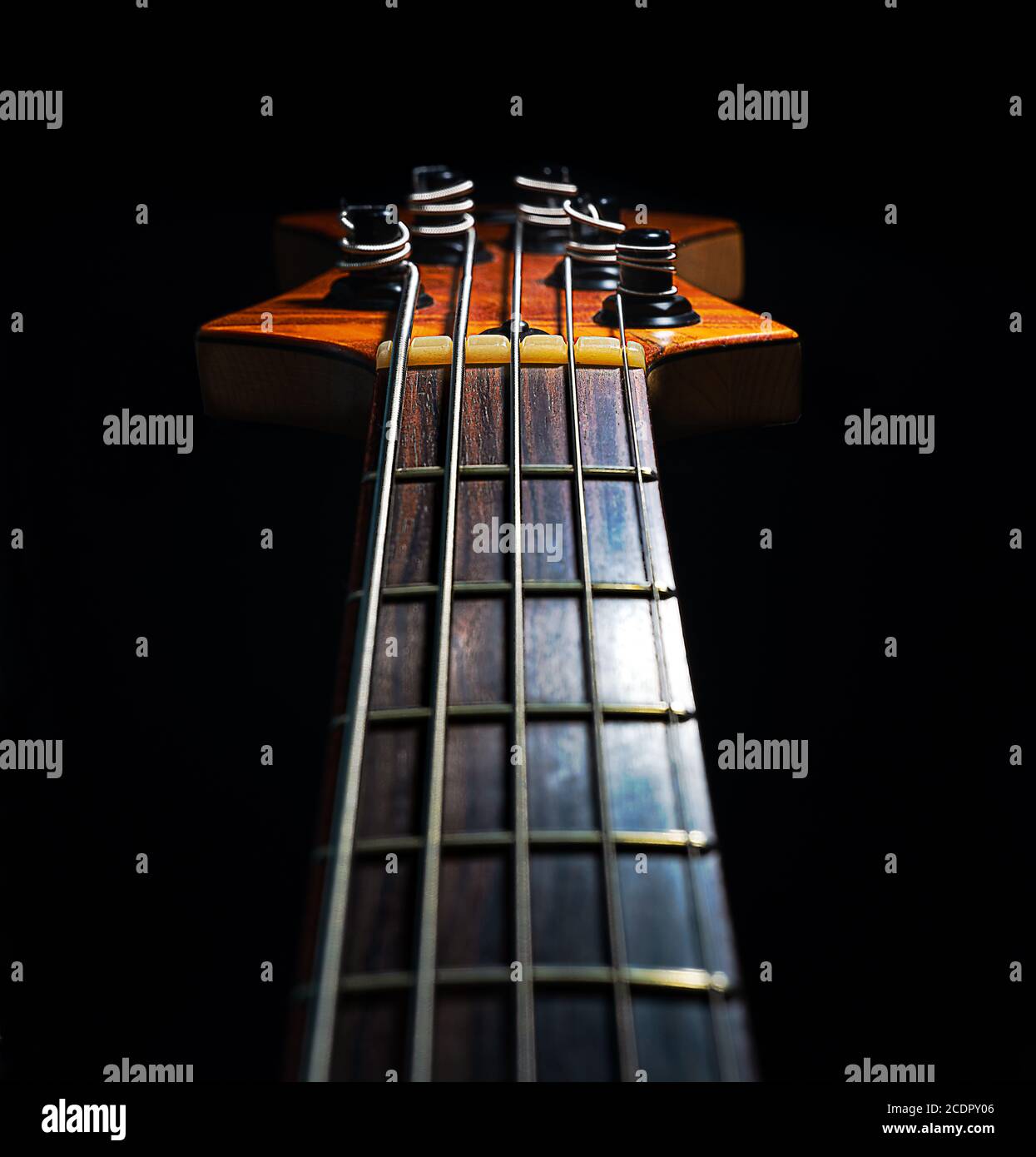 Five string electric bass guitar isolated against a black background