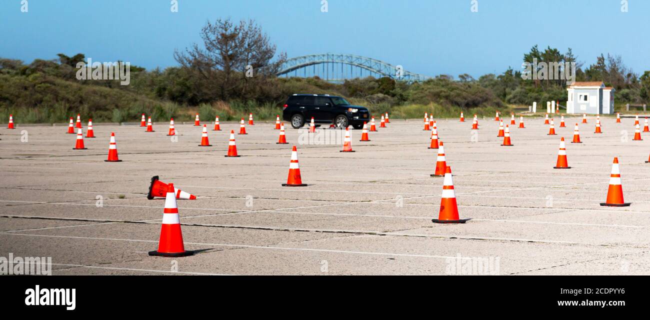Robert Moses State Park beaches parking lot with construction cones blocking every other spot for 50 percent capacity social distance because of Corna Stock Photo