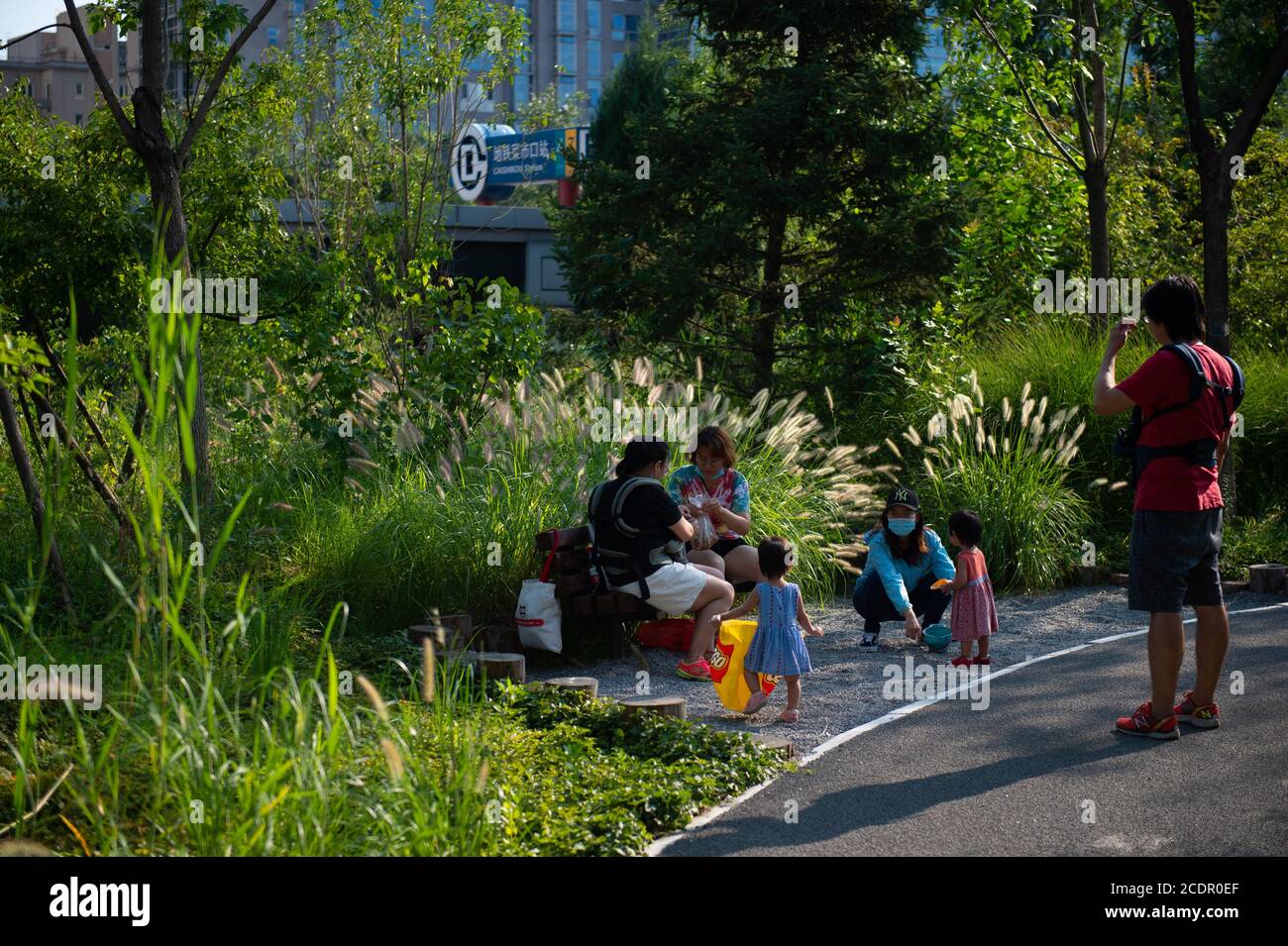 Beijing, China. 28th Aug, 2020. People enjoy leisure time at Guangyanggu  City Forest Park in Xicheng District of Beijing, capital of China, Aug. 28,  2020. In recent years, Beijing has been developing